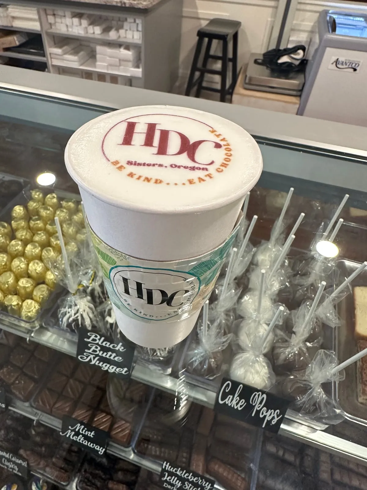 A chocolate bouquet of HDC cake pops and chocolates in a display case