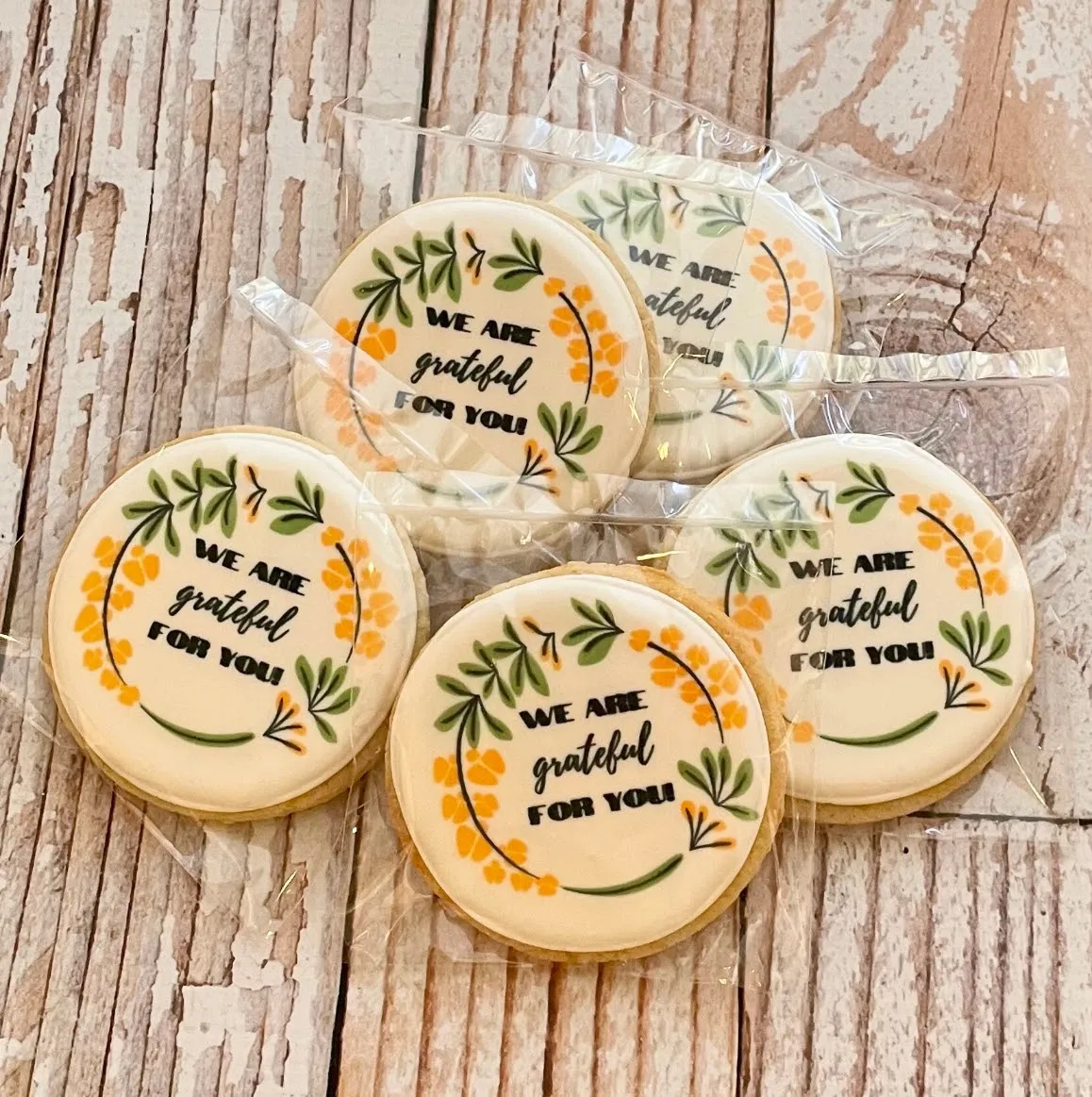 Seasonal hand-decorated sugar cookies in a painted floral wreath design