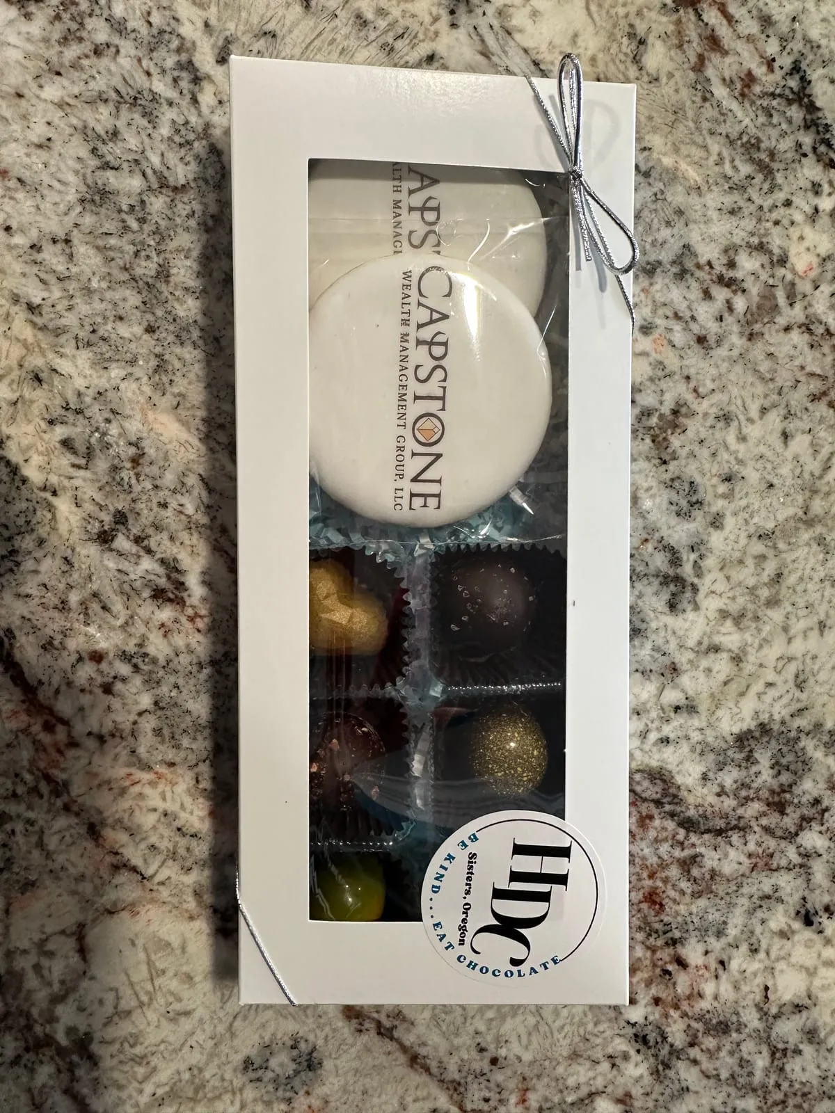 A clear gift box of logo truffles for a corporate order