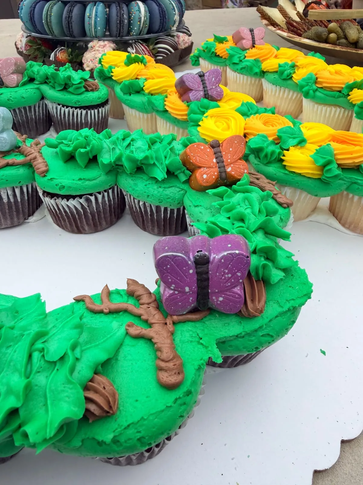 Custom themed cupcakes and a letter cake for an event