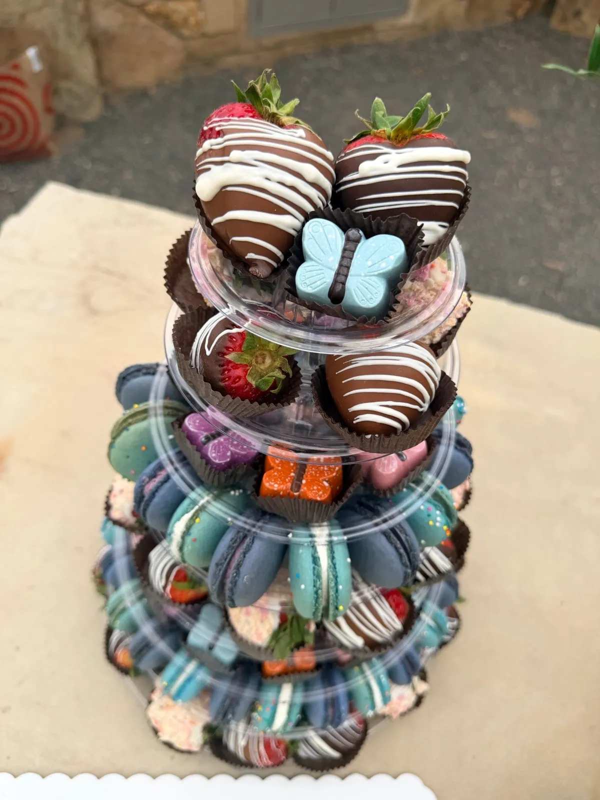 An Event Tower topped with butterfly-decorated chocolate-dipped strawberries