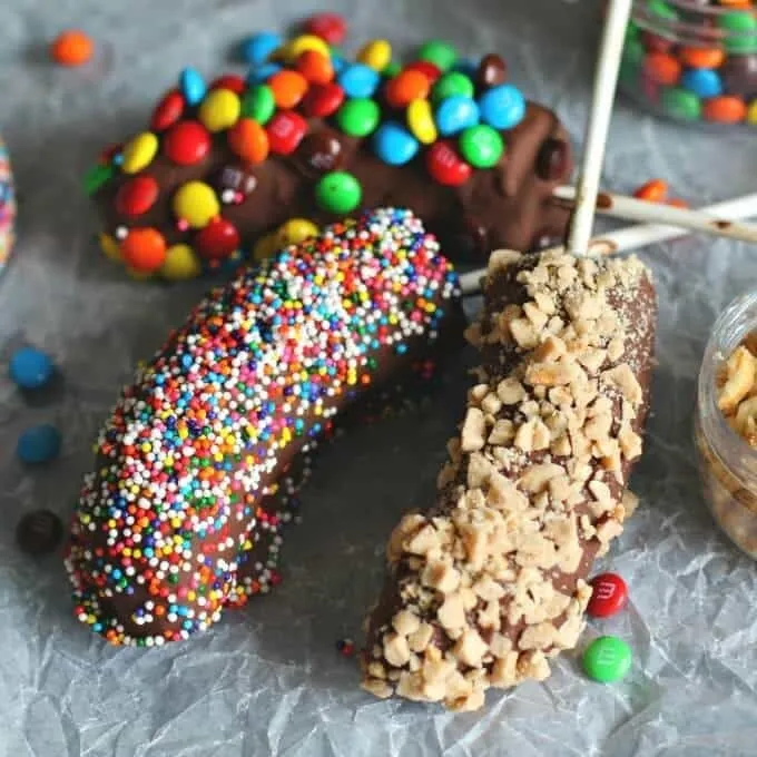 Chocolate-dipped frozen bananas rolled in sprinkles, toffee, and candy toppings