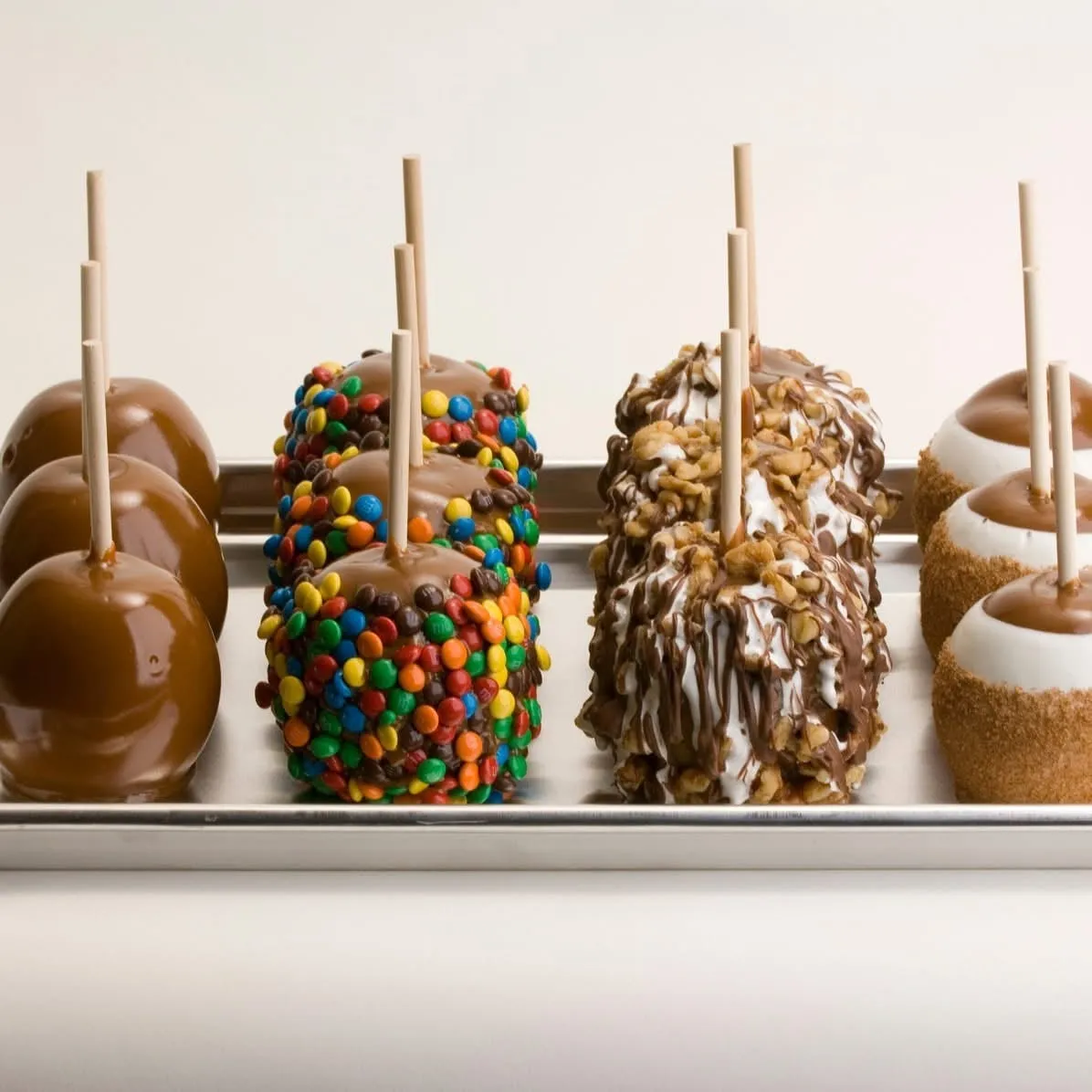 Gourmet caramel apples decorated with candy and drizzle