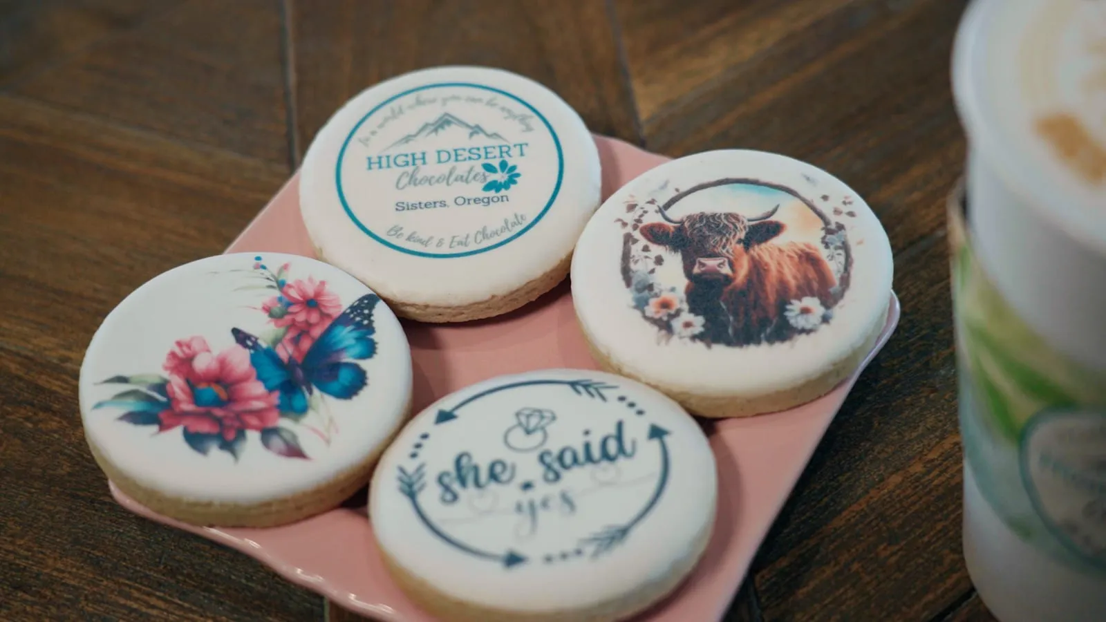Custom hand-decorated cookies for a celebration with floral and monogram designs