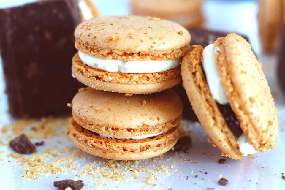 S'mores macarons close-up - graham cracker dusted shells with marshmallow filling