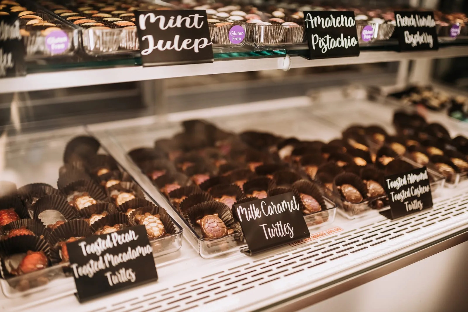 The display case of hand-rolled artisan truffles with flavor labels
